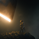 A woman stands beneath a glowing structure in a scene from Apple TV+ sci-fi series Foundation.